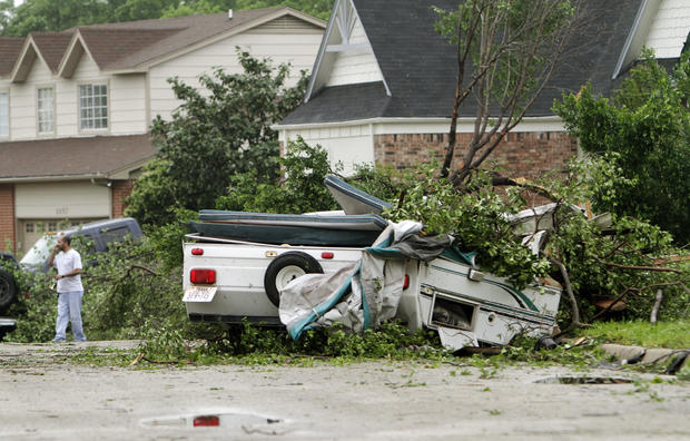 A damaged trailer remains in the street after a tornado swept through the Arlington 