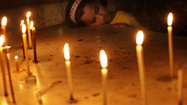 A Catholic worshipper pauses after participating in Good Friday processions inside the Church of the Holy Sepulchre, traditionally believed to be the burial site of Jesus Christ, April 6, 2012. 