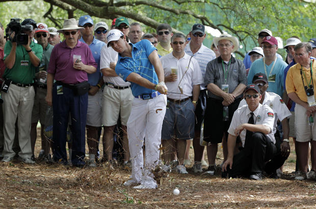 Rory McIlroy, of Northern Ireland, hits out of the rough off the first fairway 