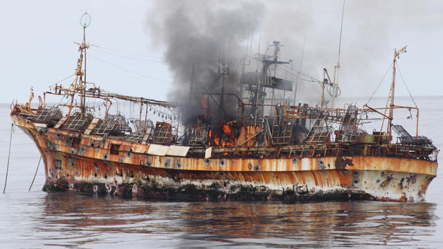 Smoke rises from the derelict Japanese ship Ryou-Un Maru after it was hit by canon fire by a U.S. Coast Guard cutter 