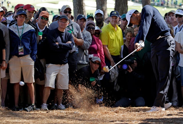 Tiger Woods hits out of trees off the eighth fairway  