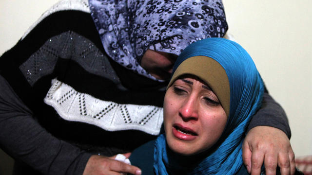 A sister, right, and an unidentified relative of Ali Shaaban, a television cameraman working for the Al Jadeed television station who was shot dead on the Lebanon-Syria border, mourn at their home in Beirut April 9, 2012. 