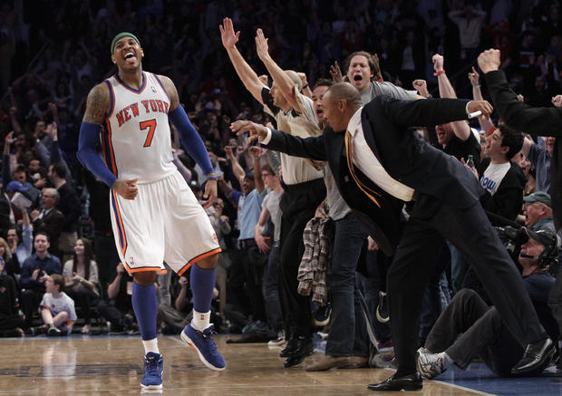 Carmelo Anthony and fans react after Anthony scored a 3-point basket  