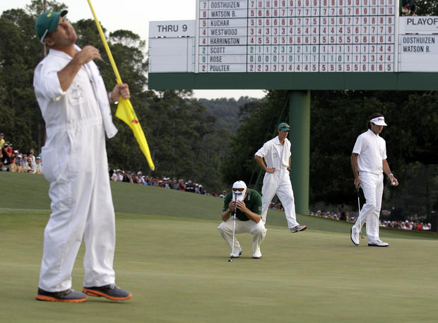 Louis Oosthuizen and his caddie Wynand Stander react after Oosthuizen missed a birdie putt 