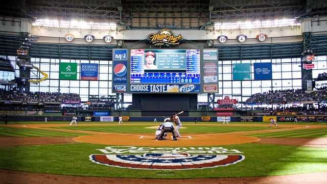 The first pitch is thrown by Milwaukee Brewers' starter Yovani Gallardo  