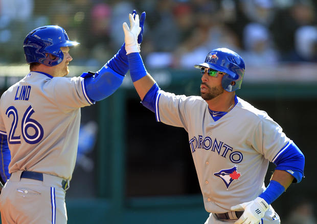 Jose Bautista is greeted by Adam Lind  
