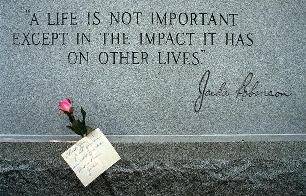 A single rose with a handwritten note rests at the grave of baseball Hall-of-Famer Jackie Robinson 
