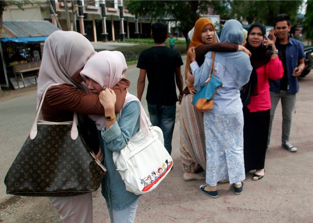 Acehnese women comfort each other after a strong earthquake was felt in Banda Aceh 