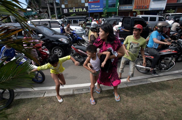 Acehnese people run shortly after a powerful earthquake hit western coast of Sumatera  