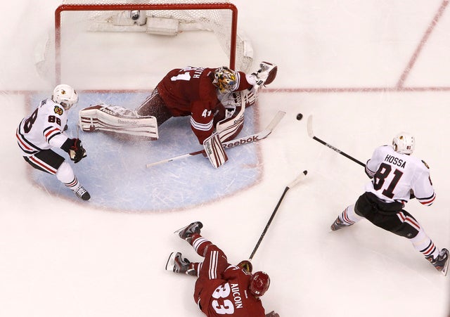Mike Smith makes a save on a shot by Marian Hossa  