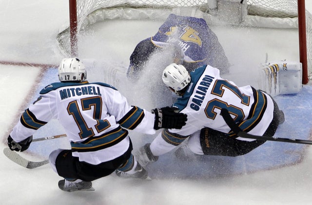 Jaroslav Halak is sprayed by San Jose Sharks' Torrey Mitchell 