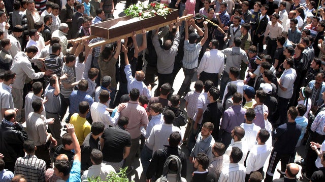 Syrians gather for a funeral for 6-year-old Yousef al-Najjar in Douma, Syria, April 16, 2012. The boy's family says he as was shot in the chest when Syrian forces opened fire on the family car. 