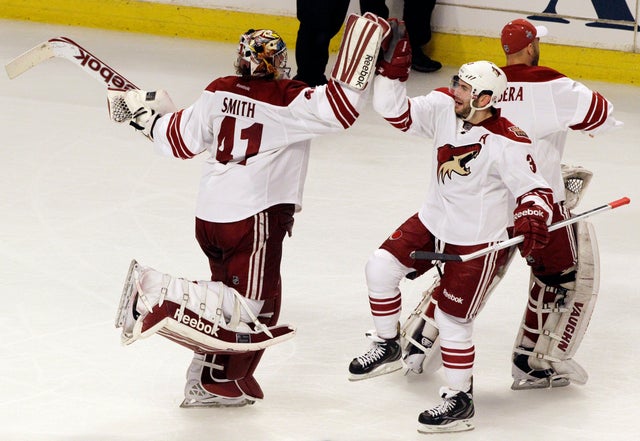 Mike Smith celebrates with Keith Yandle  