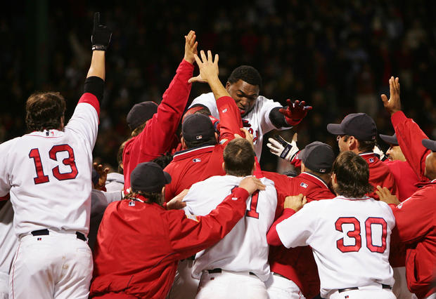 David Ortiz celebrates with his teammates after hitting the game winning two-run home run 