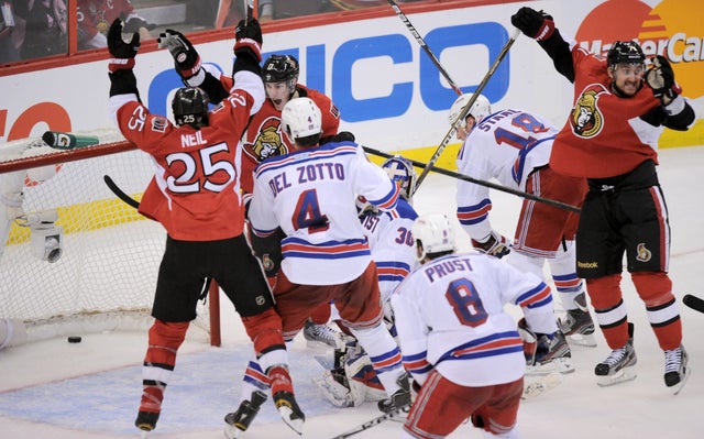 Senators' Chris Neil (25), left, Kyle Turris, rear left, and Nick Foligno, right, celebrate a goal by Sergei Gonchar 