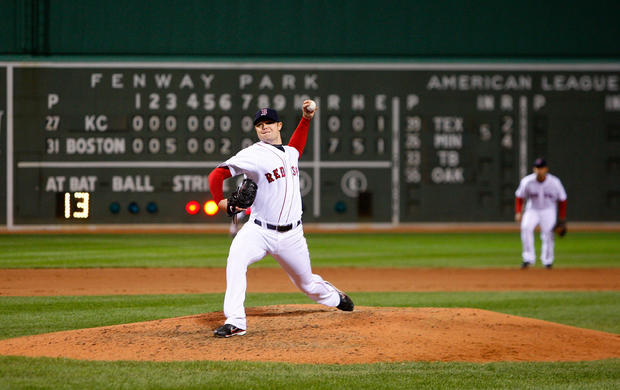 Jon Lester  throws a pitch in the ninth inning 