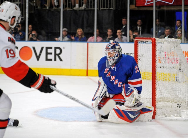 Jason Spezza scores a goal against Henrik Lundqvist 