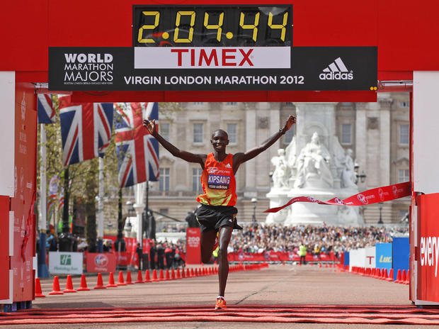 Kenya's Wilson Kipsang celebrate his win as he crosses the finish line during the London Marathon 