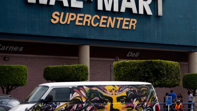 A van covered by a mural sits parked outside a Wal-Mart Super Center in Mexico City April 21, 2012. 