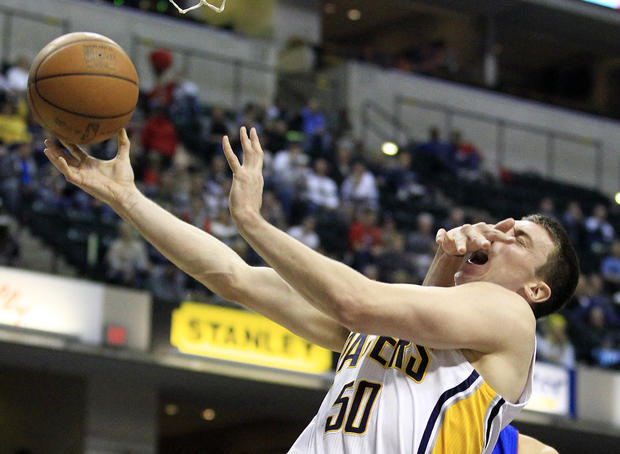 Indiana Pacers' Tyler Hansbrough is fouled by Detroit Pistons' Austin Daye  