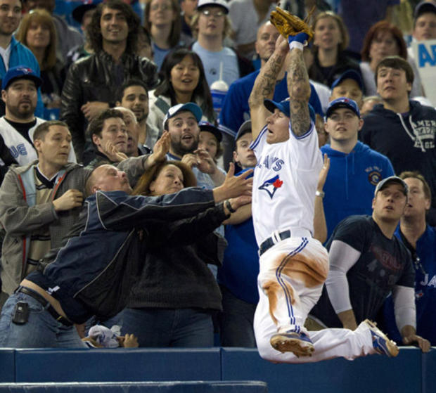 Brett Lawrie leaps into the crowd to catch a foul pop fly 