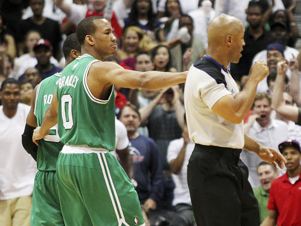 Avery Bradley puts his arm around Rajon Rondo and walks him off the court as he is ejected 