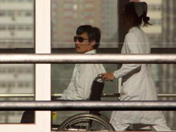 Chinese activist Chen Guangcheng is seen in a wheelchair pushed by a nurse at the Chaoyang hospital in Beijing May 2, 2012. 