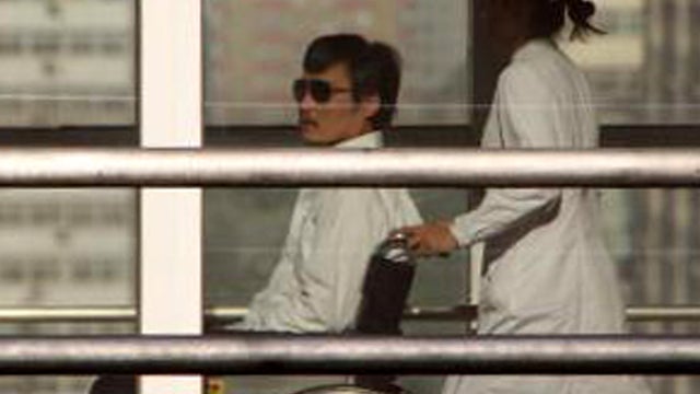 Chinese activist Chen Guangcheng is seen in a wheelchair pushed by a nurse at the Chaoyang hospital in Beijing May 2, 2012. 