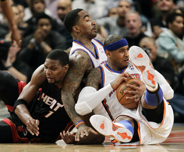 Chris Bosh and Carmelo Anthony scramble for a loose ball 