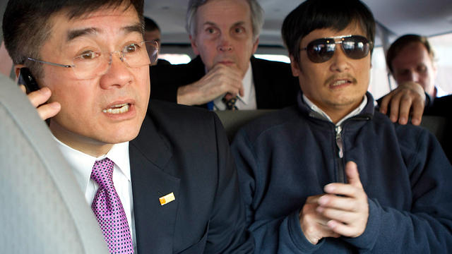 Chinese dissident Chen Guangcheng, right, looks on as U.S. Ambassador to China Gary Locke talks on the phone May 2, 2012, in Beijing in this handout photograph provided by the U.S. Embassy Beijing press office. 