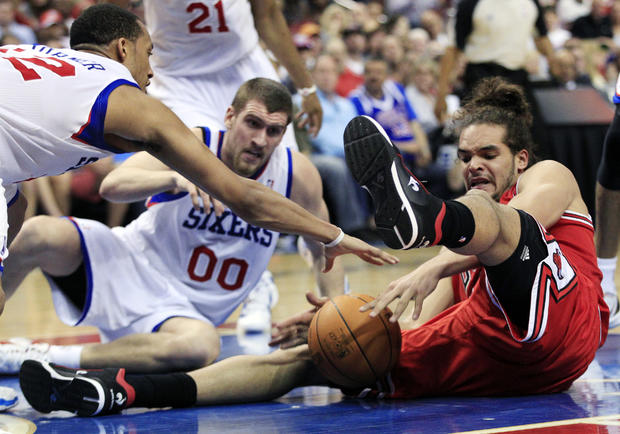  Evan Turner, left, and Spencer Hawes, center, grab for the ball  