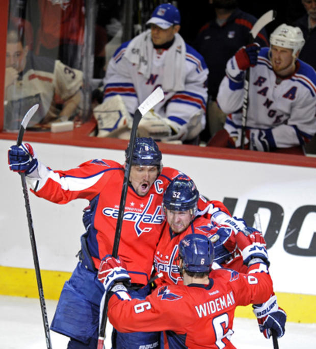 Mike Green, center, celebrates his goal with teammates Alex Ovechkin (8) and Dennis Wideman (6)   