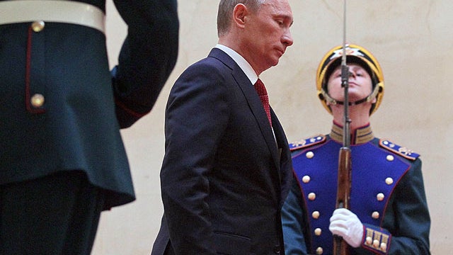 Vladimir Putin walks past honor guards heading for his inauguration in the Grand Kremlin Palace in Moscow on May 7, 2012.  