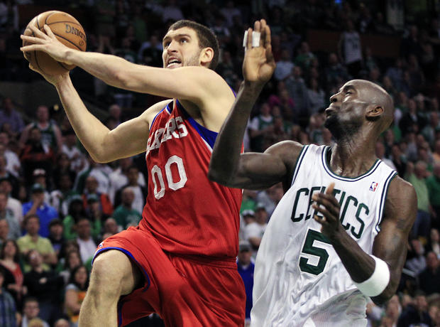 Spencer Hawes drives to the basket  