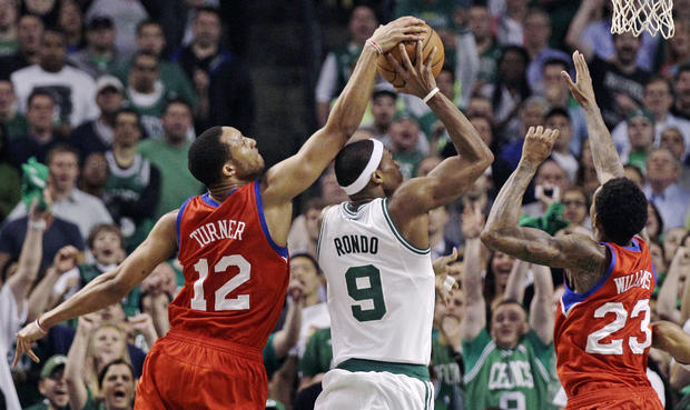 Evan Turner reaches over the top to block a shot by Rajon Rondo 