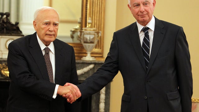 Greek President Karolos Papoulias, left, with the newly appointed caretaker Prime Minister Panagiotis Pikrammenos during the swearing-in ceremony at the Presidential Palace in Athens, Wednesday, May 16, 2012. 