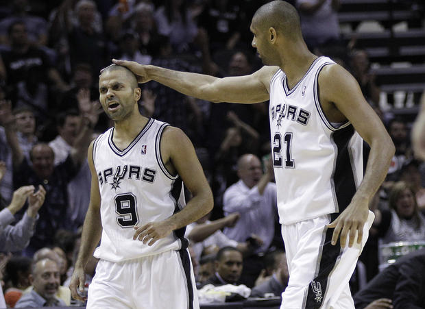 Tony Parker gets a pat on the head from teammate Tim Duncan 