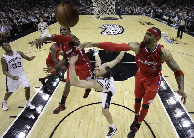 Manu Ginobili is fouled as he drives to the basket 