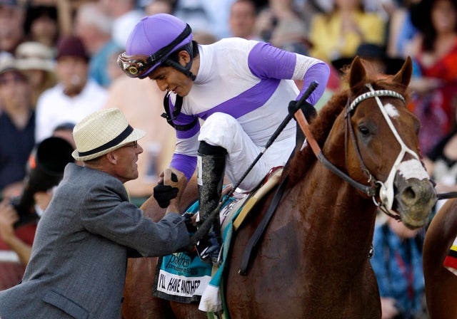 Mario Gutierrez aboard I'll Have Another, is congratulated by bloodstock agent Dennis O'Neill 