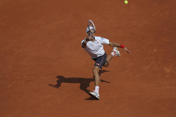 Novak Djokovic returns in his first round match against Potito Starace 