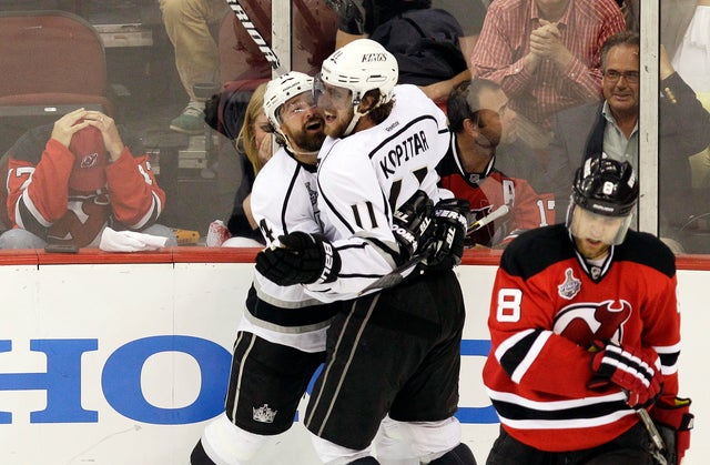 Anze Kopitar celebrates with teammate Justin Williams after scoring the game-winning goal  