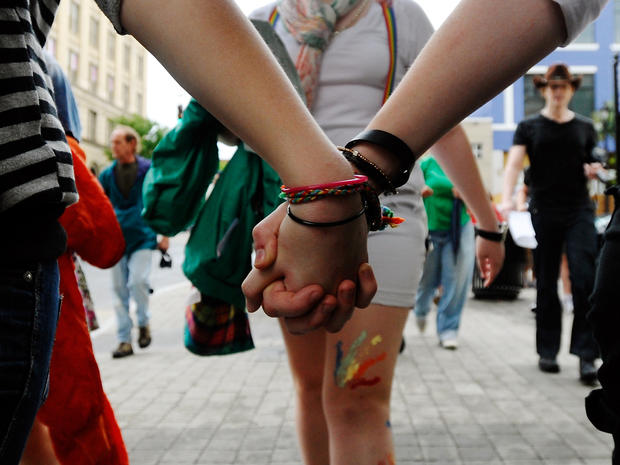 Two women hold hands in protest of the recently passed Constitutional Amendment One in the North Carolina primary May 14, 2012, in Raleigh, N.C. 