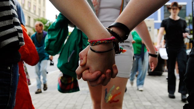 Two women hold hands in protest of the recently passed Constitutional Amendment One in the North Carolina primary May 14, 2012, in Raleigh, N.C. 