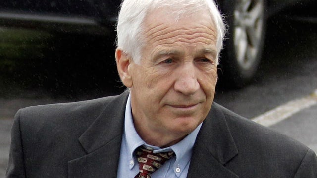 Former Penn State University assistant football coach Jerry Sandusky, center, arrives with his attorney Joe Amendola June 5, 2012, for the first day of jury selection at a courthouse in Bellefonte, Pa. 