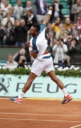 France's Jo-Wilfried Tsong jumps as he defeats Switzerland's Stanislas Wawrinka 