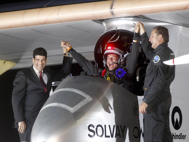 Solar Impulse pilots celebrate with a Moroccan solar energy official 