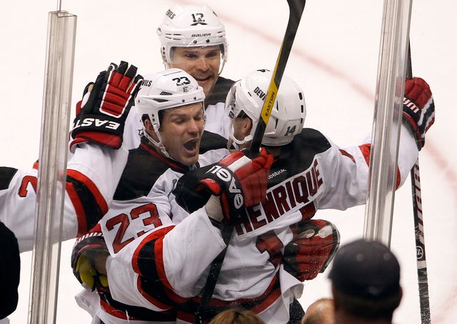 Adam Henrique celebrates with teammates  