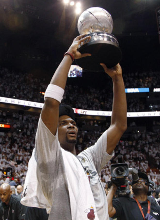 Chris Bosh holds the NBA's Eastern Conference trophy  