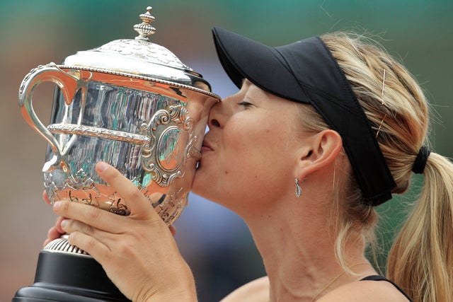 Maria Sharapova of Russia holds the trophy after winning the women's final match 