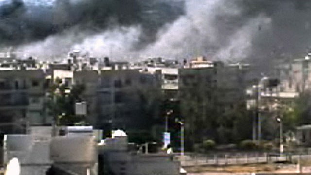 This video image taken from amateur video and broadcast by Bambuser/Homslive shows a series of devastating explosions rocking the central Syrian city of Homs, Syria, Monday, June 11, 2012 